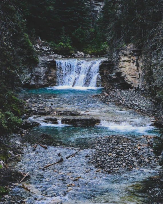 a stream that has water tumbling over rocks