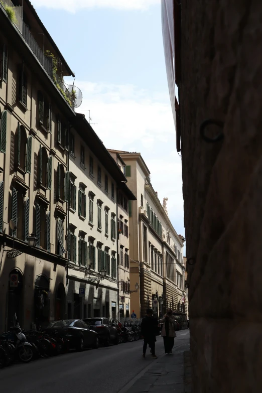 a city street has several buildings with black shutters