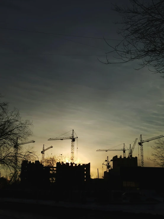 the silhouette of many building against a dark sky