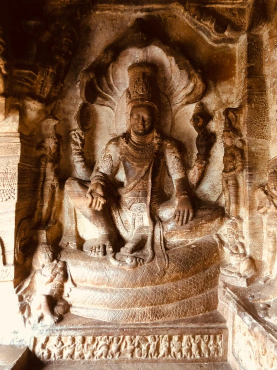 a stone sculpture of a person sitting on a pedestal