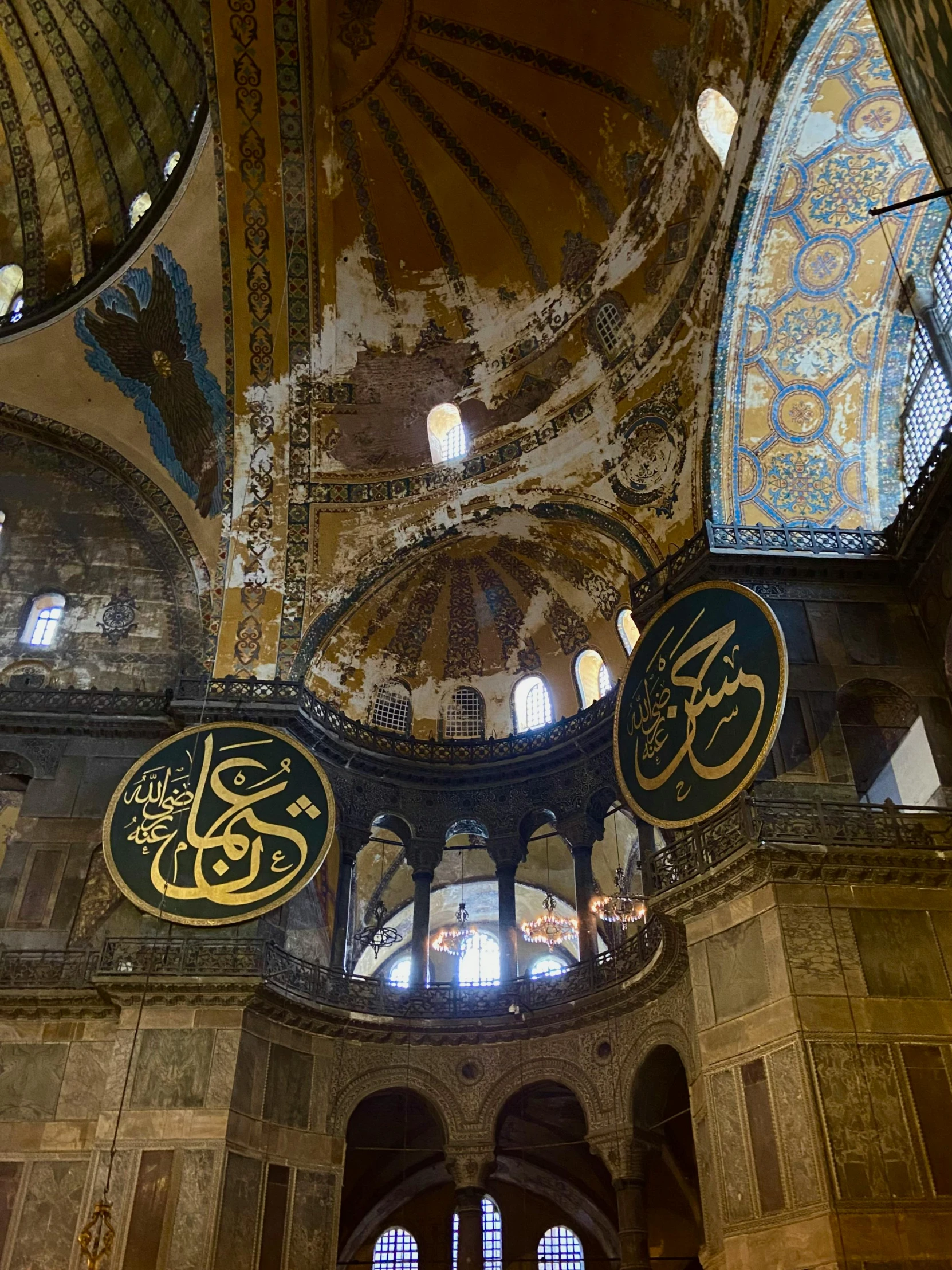 an oriental mosque with two circular ceiling lights and chandeliers