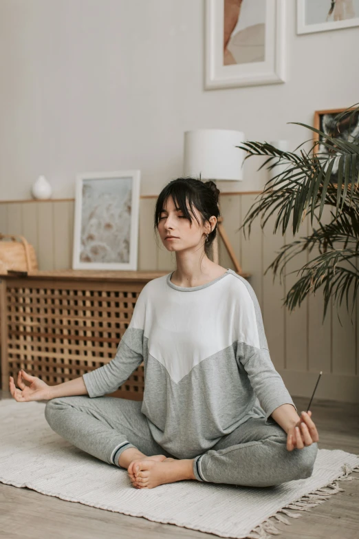 a woman sitting in a room with her hands open