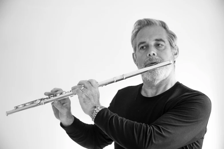 a man playing a flute in a studio