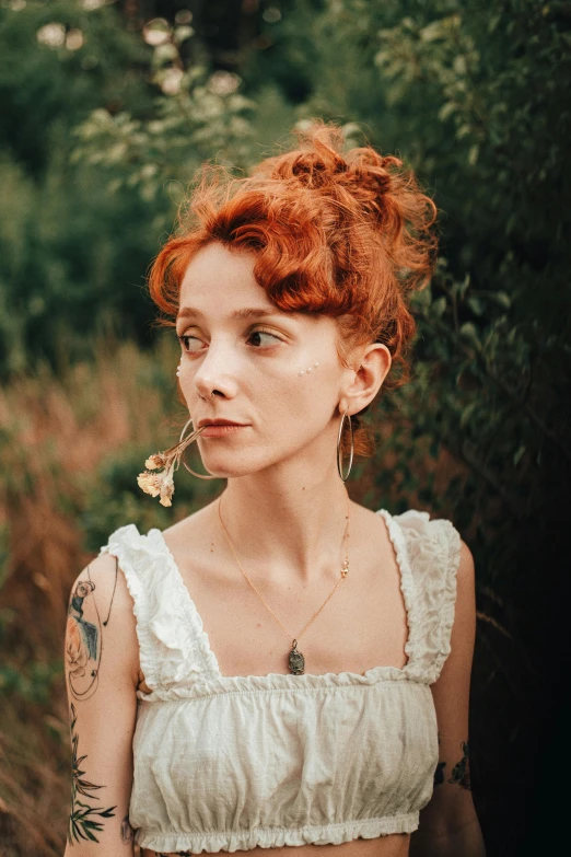 the redhead woman is wearing a flower in her mouth