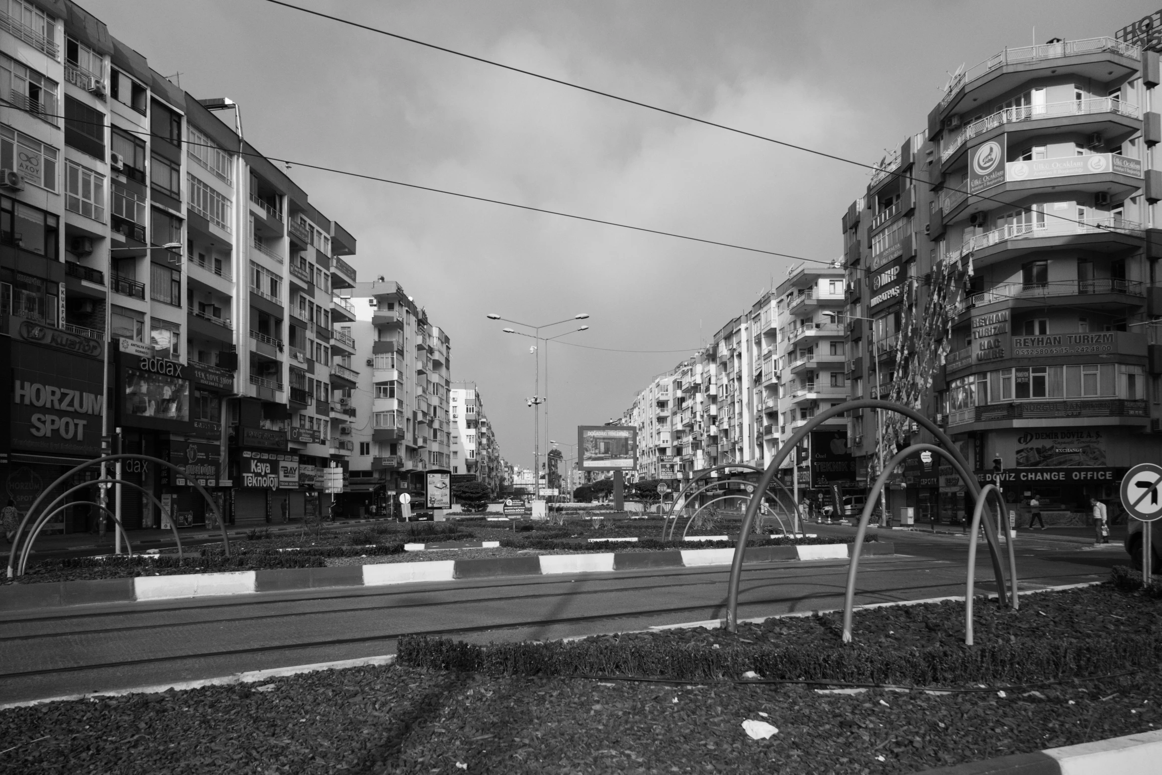 a black and white po shows a city street lined with buildings