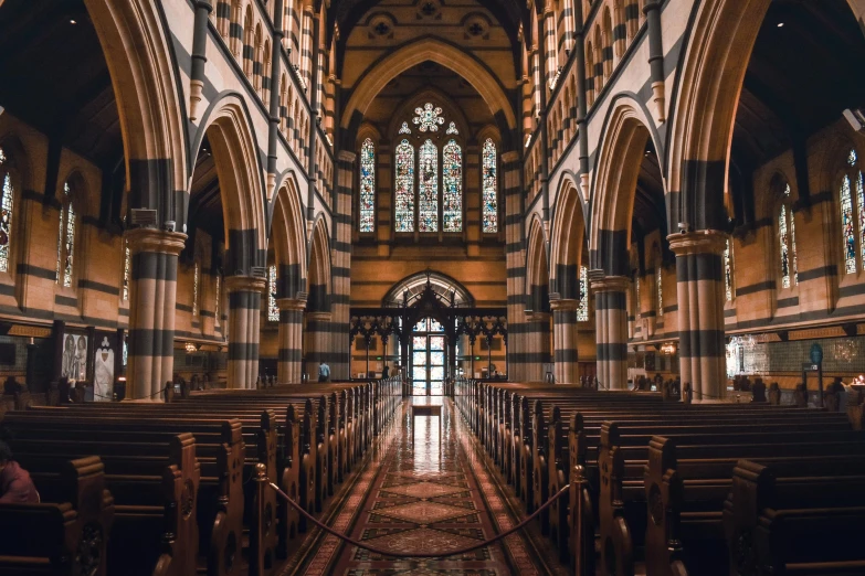 the inside of a church with two people sitting at chairs