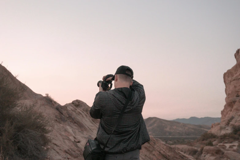 a person with his back to the camera and his hand on their face in front of them