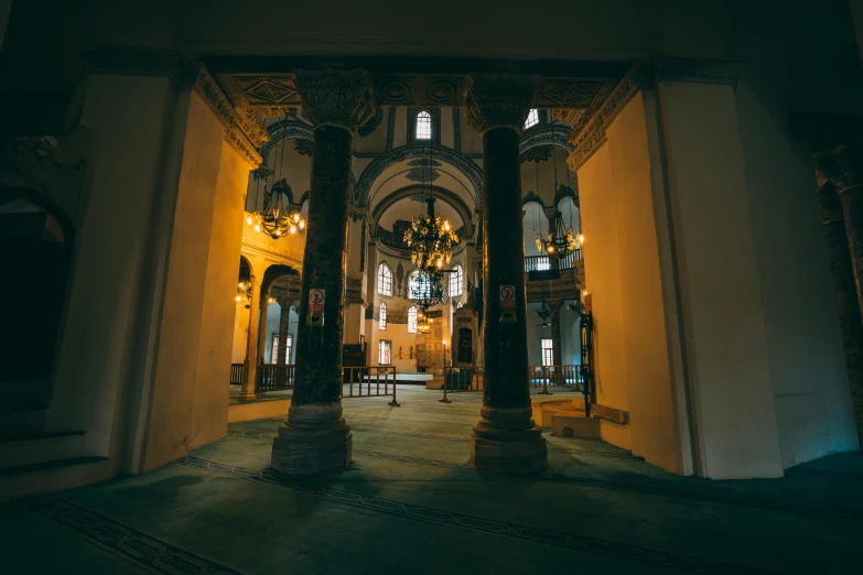 large doorway with chandeliers and clock at night