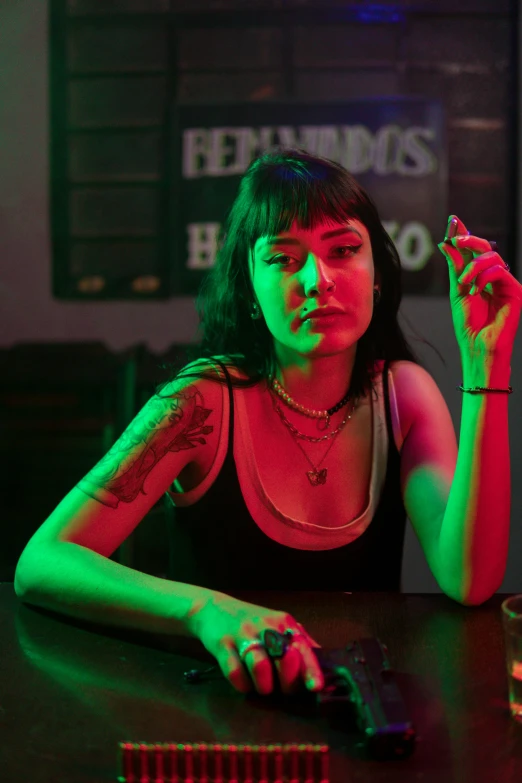 a woman at a bar holding a cigar and smoking a cigarette