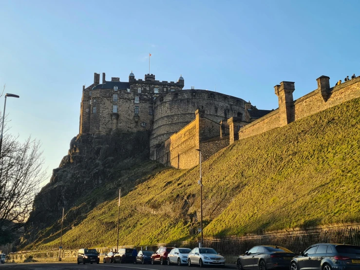 castle like structure sits on the top of a hill