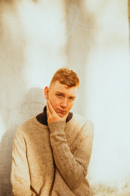 a man looking bored while wearing a sweater