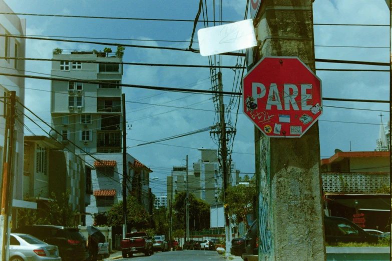 a red stop sign with foreign writing on a pole