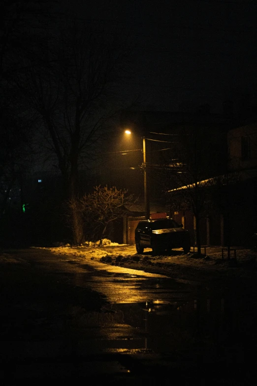 a car parked in front of a building at night