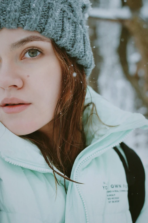 a woman with a knitted hat looking away