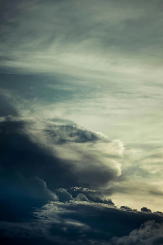 a plane flying through a cloud filled sky