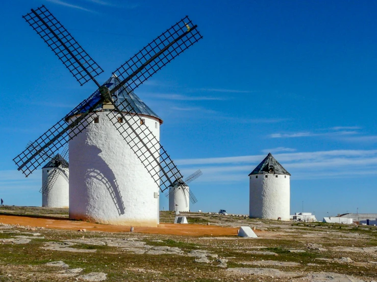 two large white windmills standing in the desert