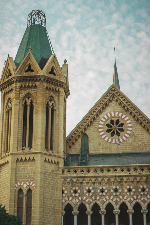 large tower of an old church building with a green roof