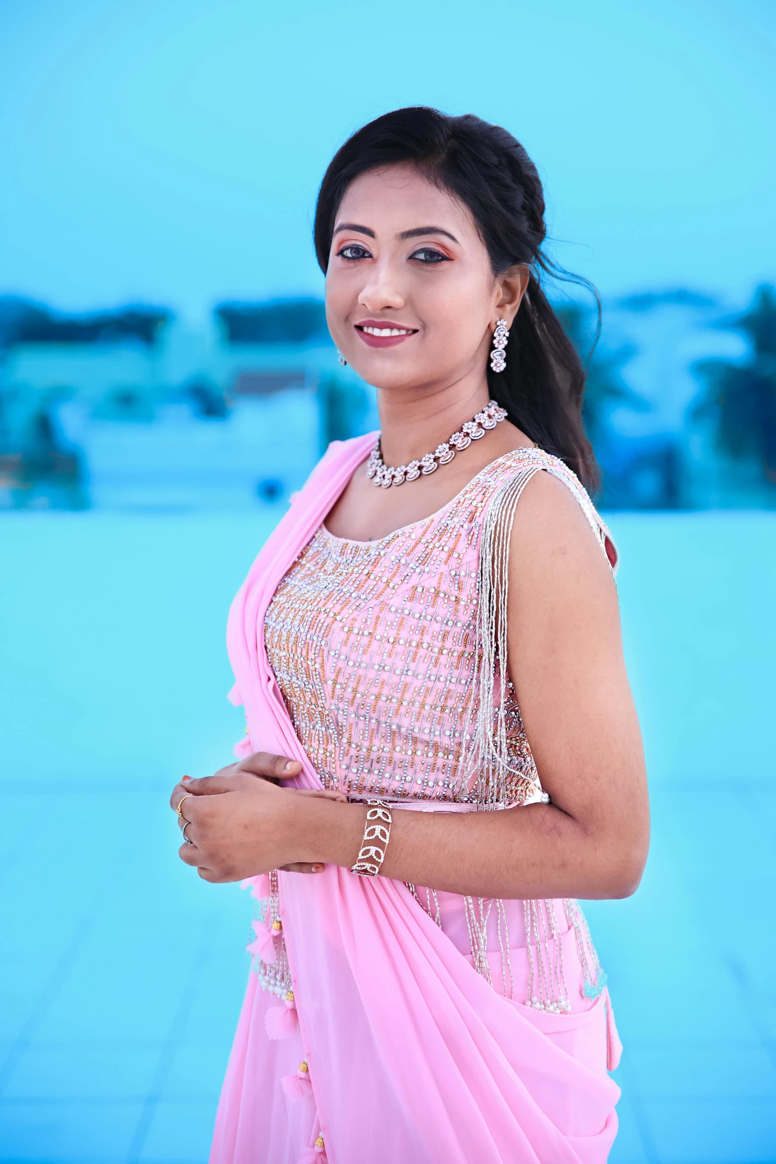 indian woman in pink dress posing for a picture