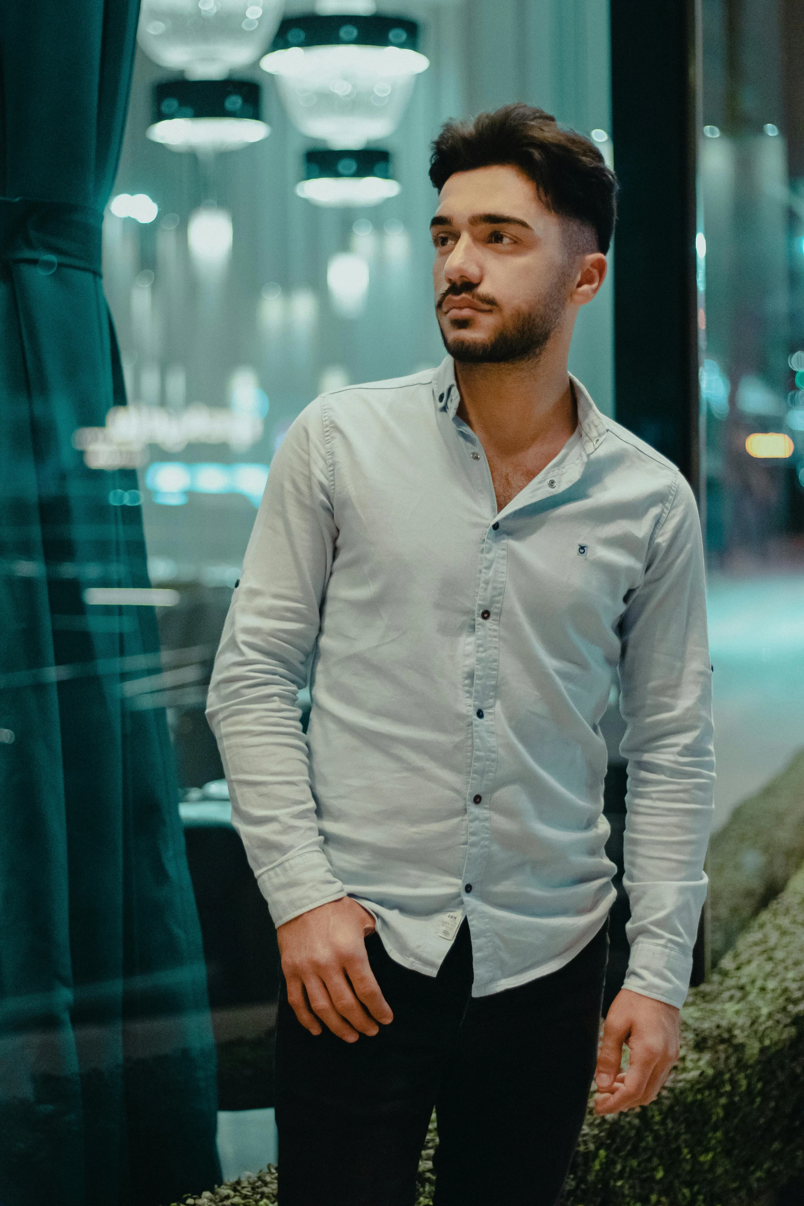 a man stands in front of a window with no people