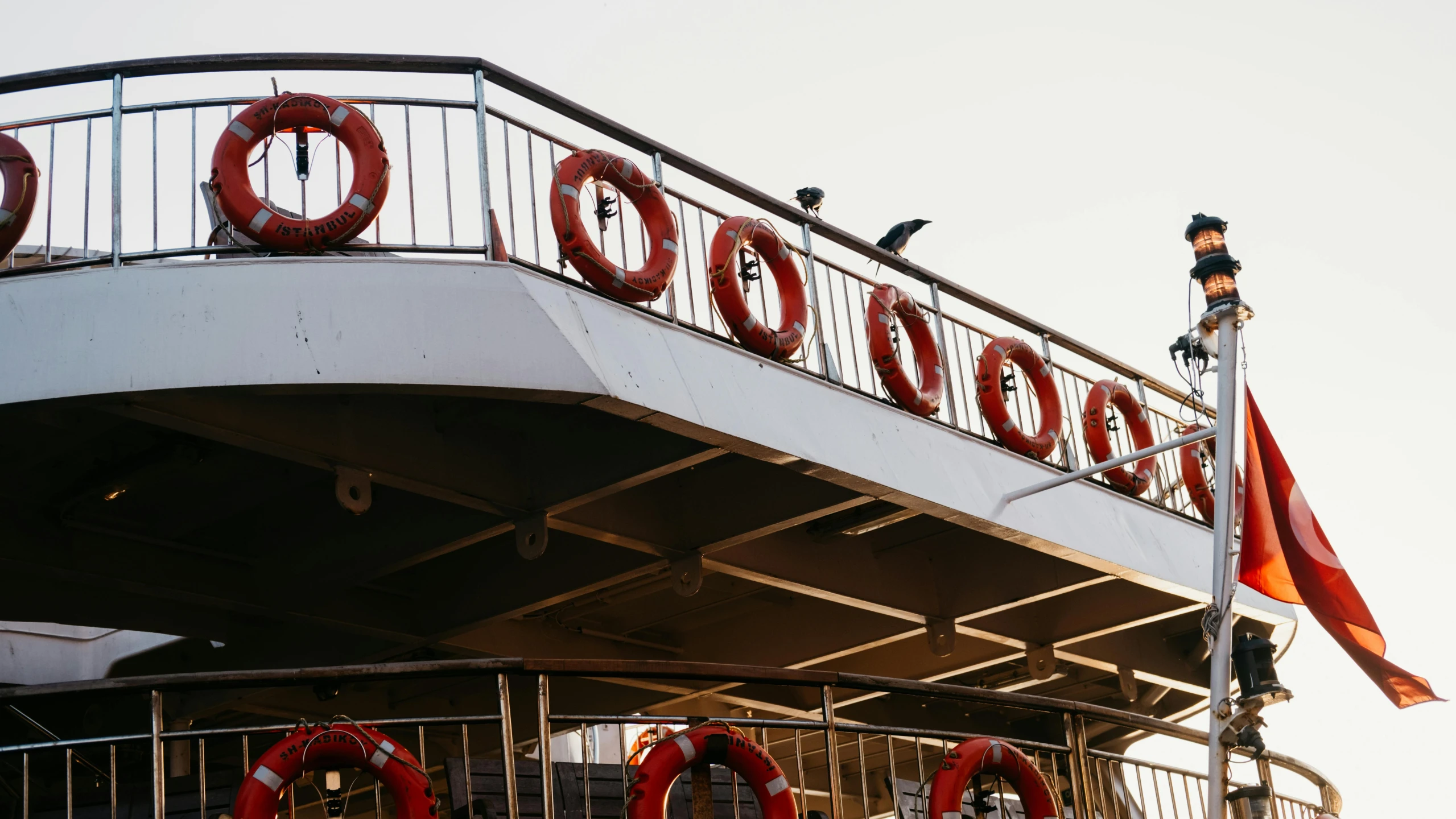 a tall red sign that says o'oop is above the railings on a boat