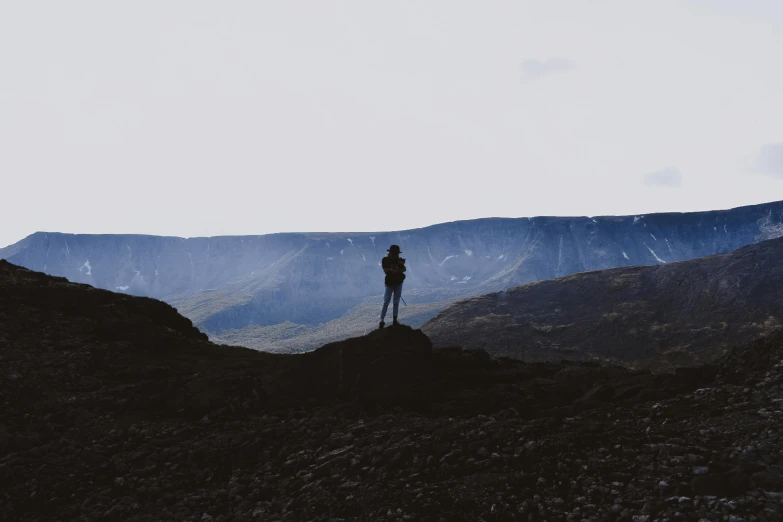 person looking into the distance with mountains in the background