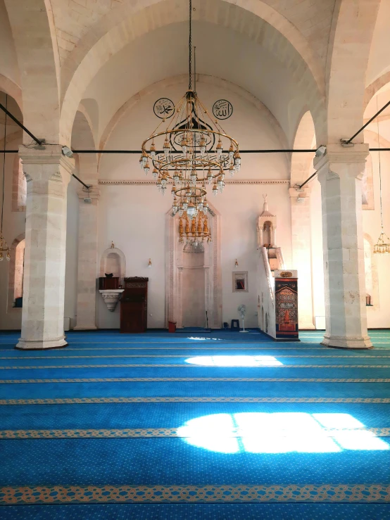 sunlight shines through the arches into a cathedral filled with pews