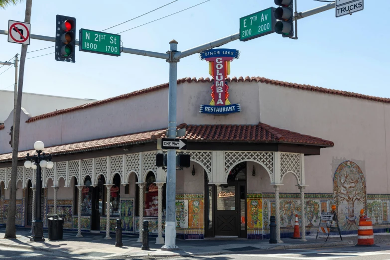 a building on the side of a road has a traffic light with street signs