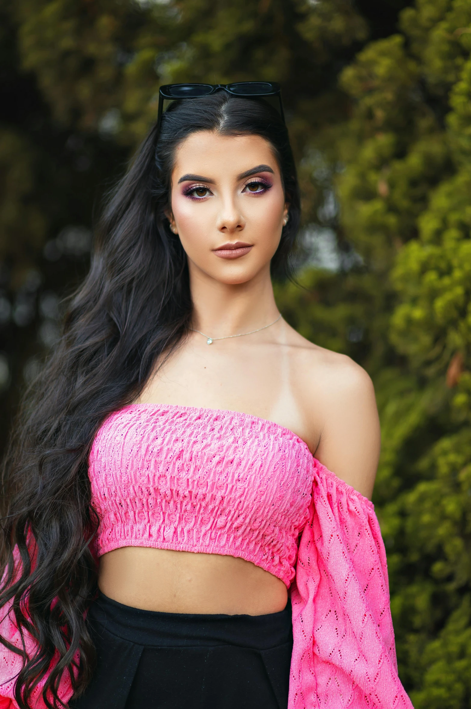 a woman posing with long hair in a pink top