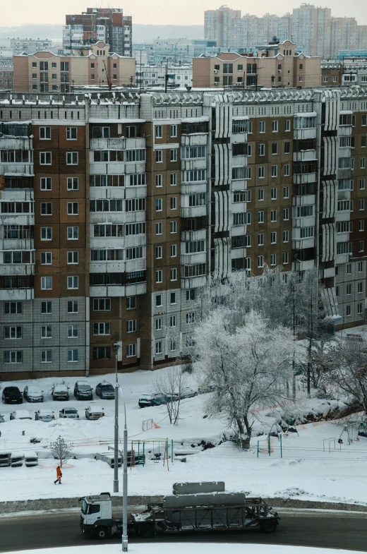 a large parking lot in front of a city filled with tall buildings