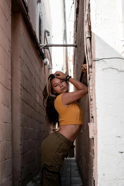 a woman leaning on the wall with a handbag