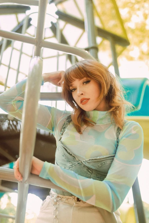 a woman is leaning on the metal rail