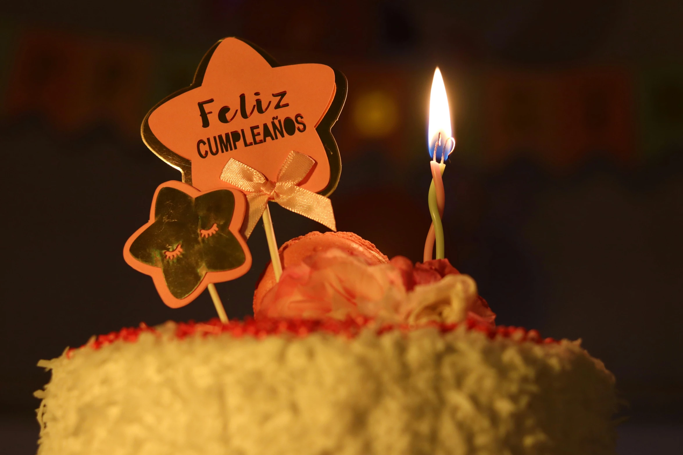 a cake is topped with candles and two decorations