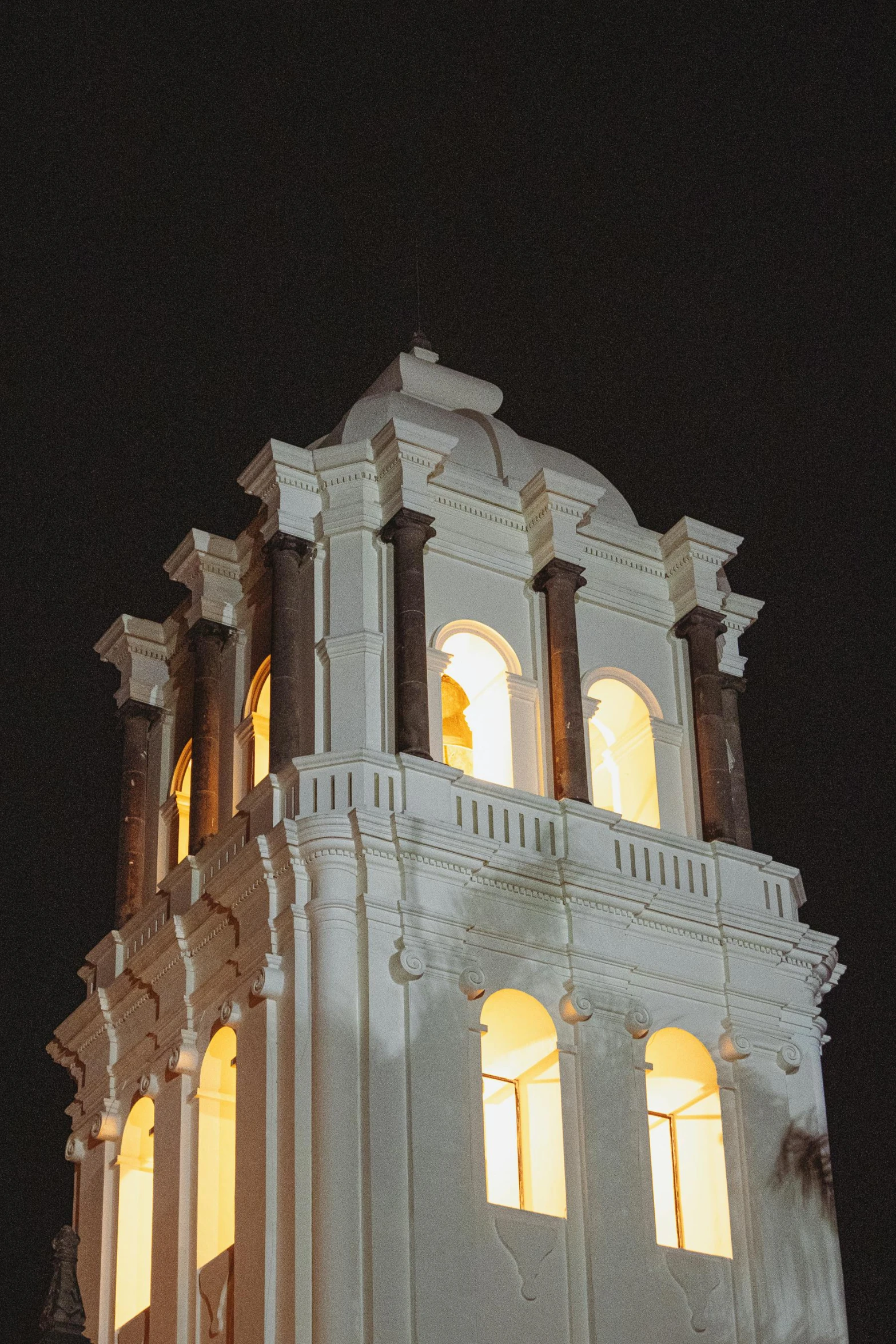 the clock is lit up in the tower