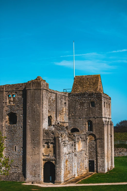 an old and rotten castle sitting on a green field