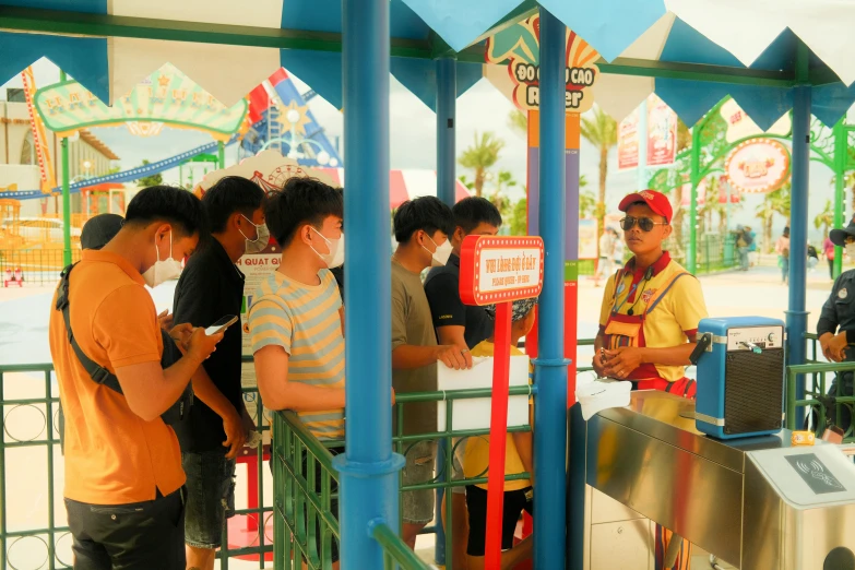 a group of people standing on a carnival fair booth