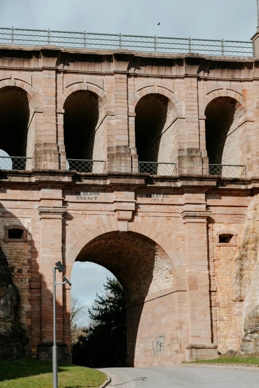 a large brick structure with an arch leading to an area