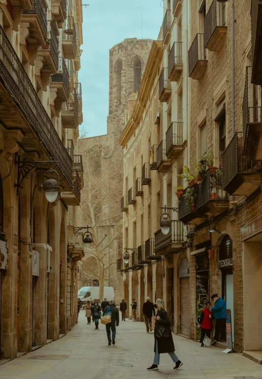 a group of people walk down an alley way