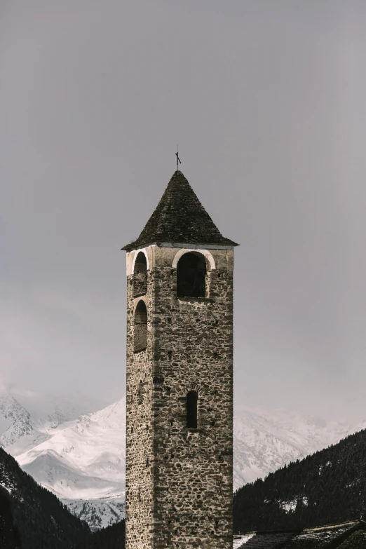 a stone building has a pointed roof and two windows