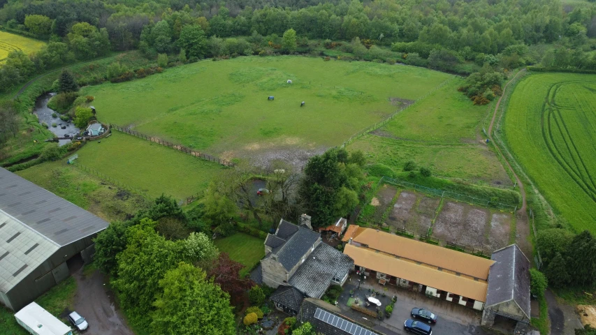 a large grassy field sitting between two buildings