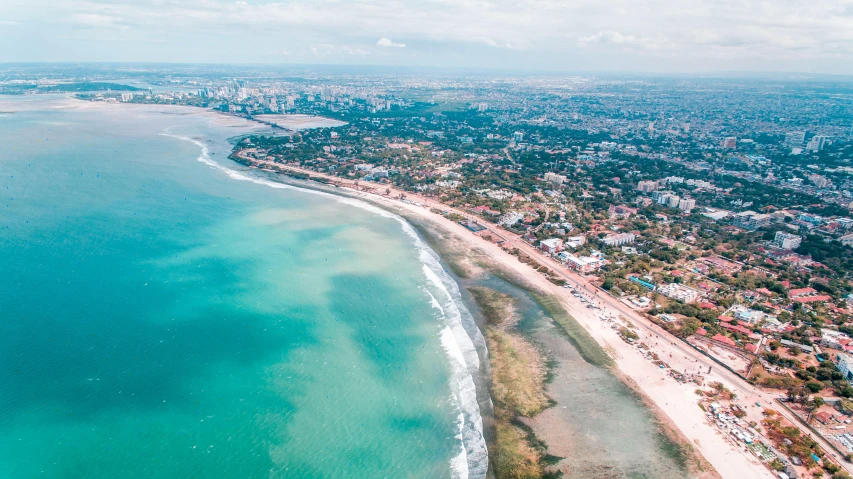 a beautiful beach next to an ocean with lots of water