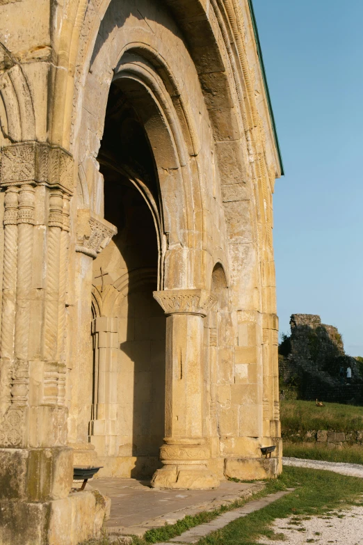 an arched doorway to another building on a sunny day