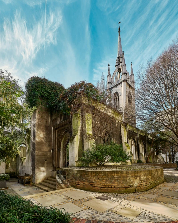 a church building with a tall tower surrounded by trees