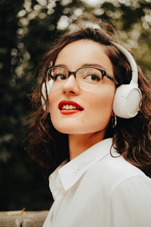 a woman with headphones is looking into the distance