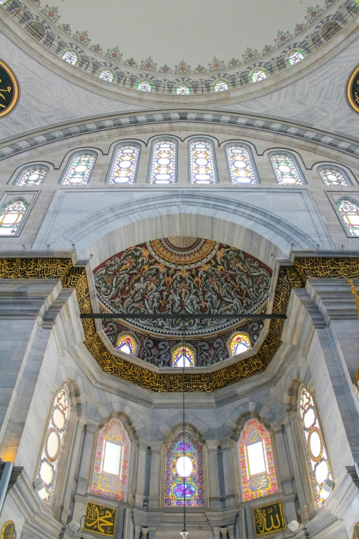 the interior of a large cathedral has stained glass