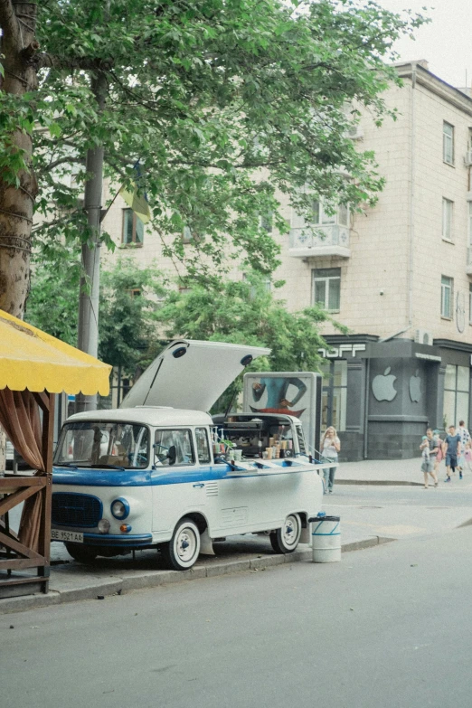 a van sitting on the side of a road under trees