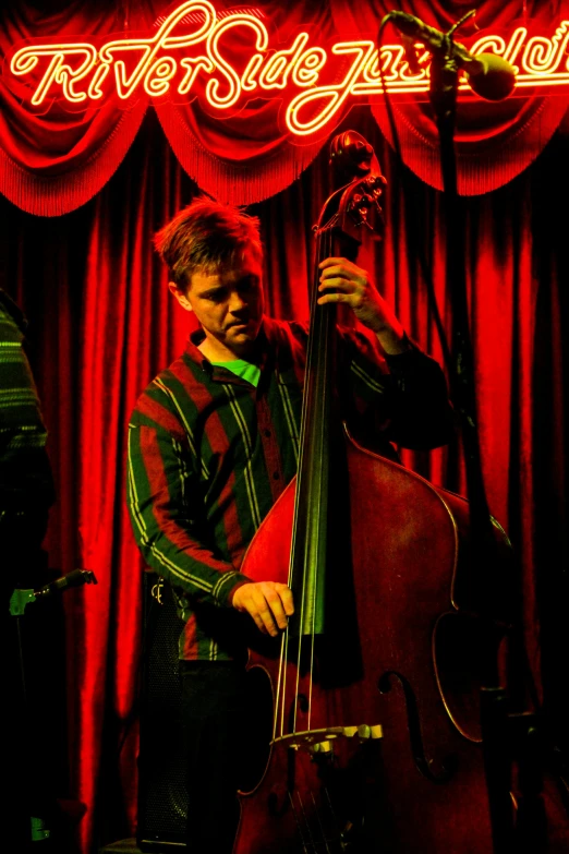 a man holding a double bass during a performance