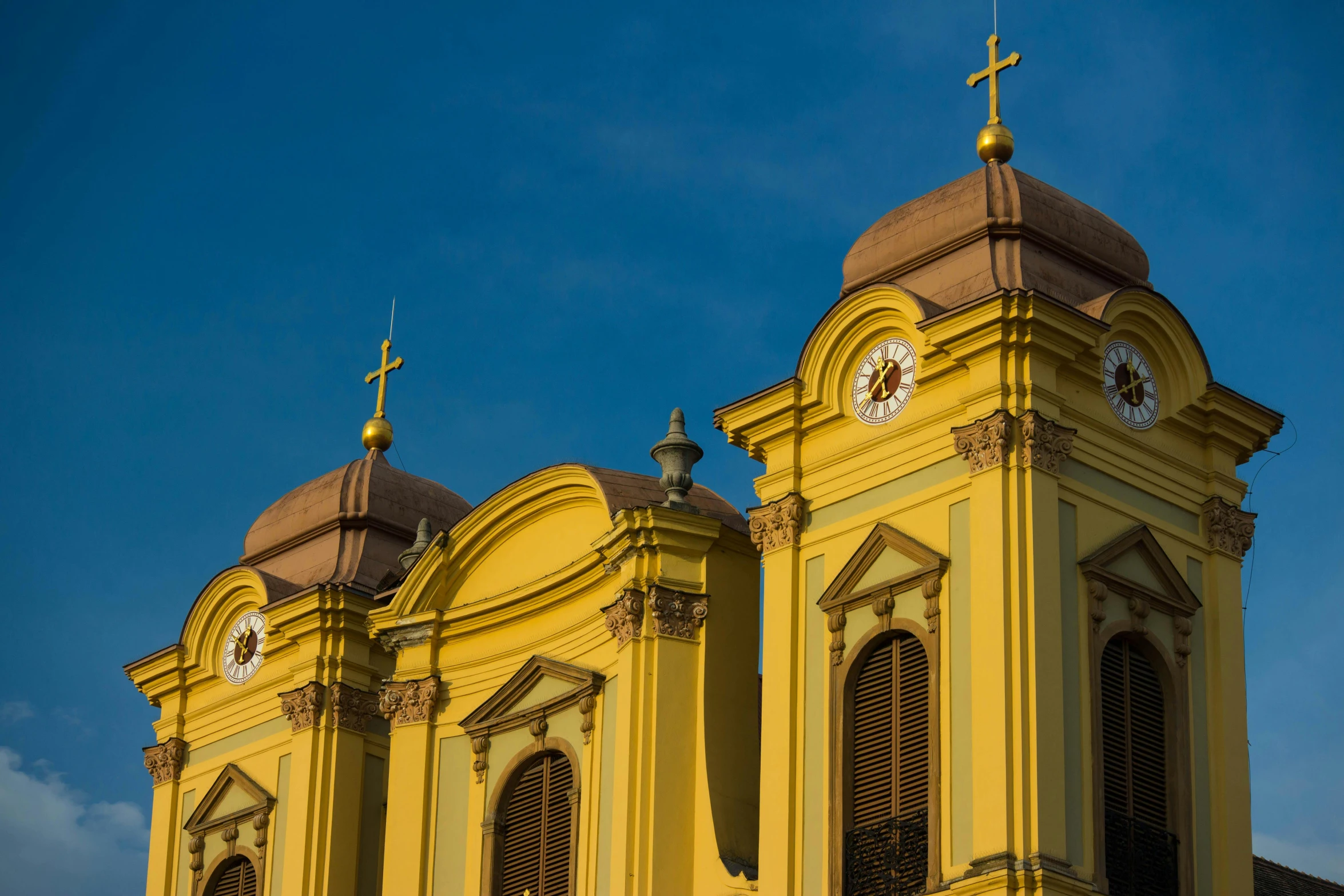 the top and side of an old cathedral with two clocks