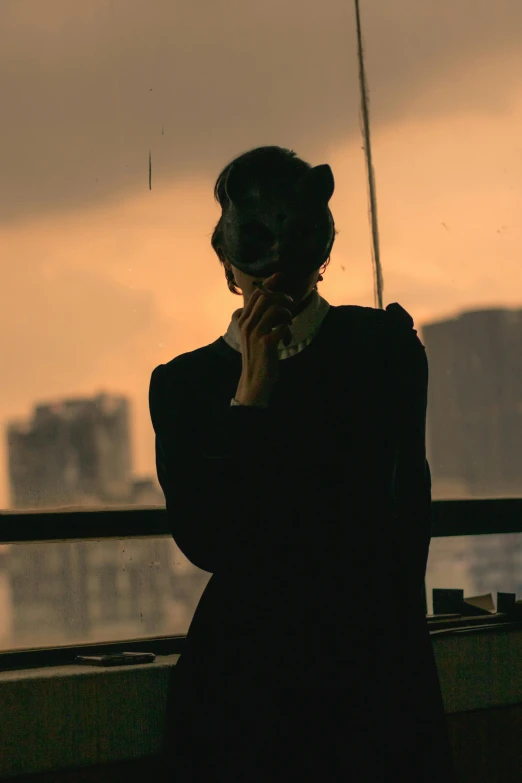 the woman is standing in front of a city view