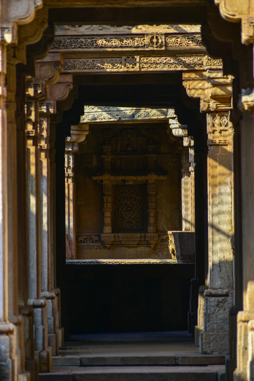 the interior of an indian temple has elaborate carvings and gold decorations