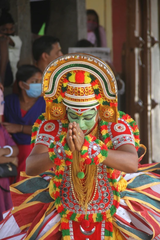 a person with painted face in colorful costume